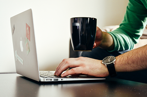 Guy with laptop and coffee mug