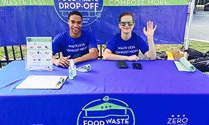 man and women at Food Waste Drop off Table